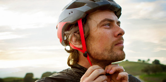 the man fastens his helmet