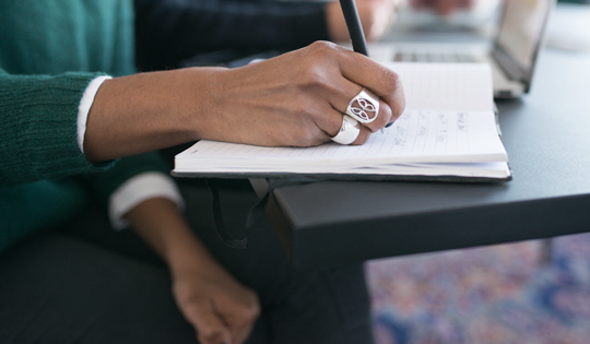 writing notes in the notebook