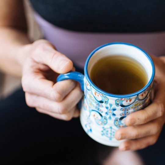 Hands holding coffee mug
