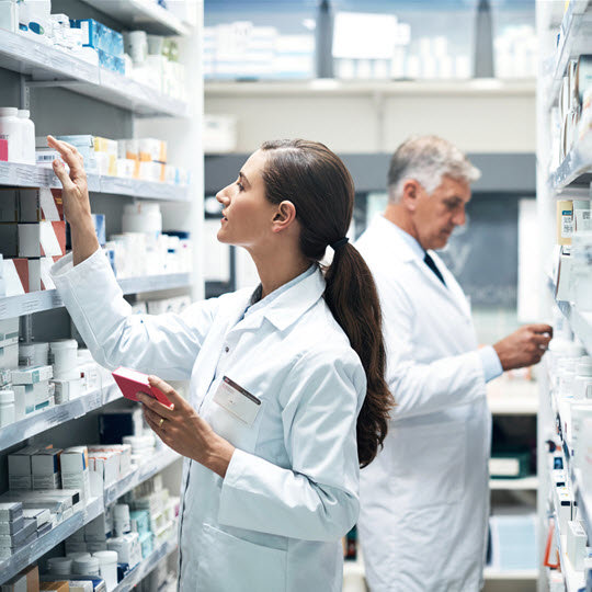 pharmacist looking at shelf