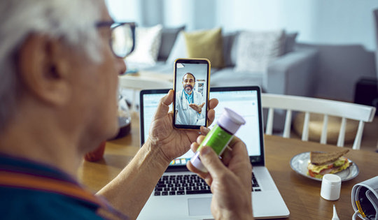 man-checking-prescription-medicine-with-mobile-doctor