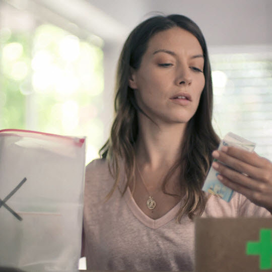 Woman checking medicine expiry