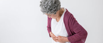Old woman holding her stomach