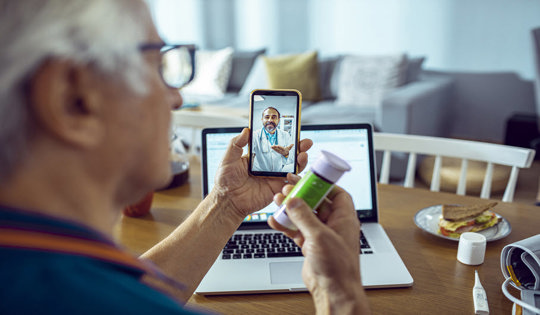 Man checking prescription medicine with mobile doctor