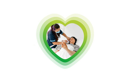 Nurse with patient in bed