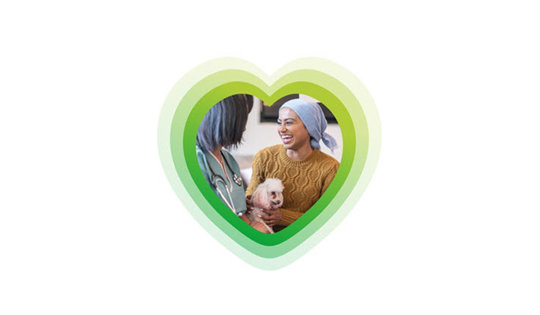 Nurse and patient laughing with a puppy