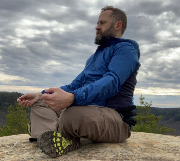 A man meditating outside