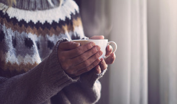 Woman holding a hot cup