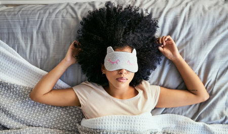 Woman in bed with a sleeping mask