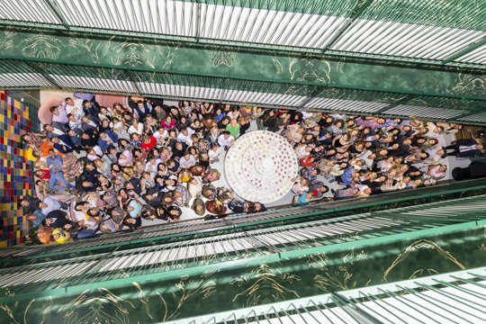 All in photo - photo with a lot of people in a room looking down