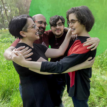 Family of Teva employee Smadar Tabenkin Ezer embracing outside in Israel