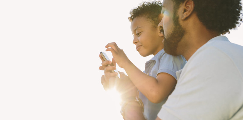 Father and son watching mobile phone