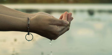 Hands holding some water