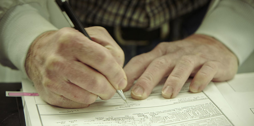 A person writing his signature