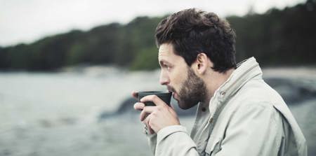 Man drinking at the beach