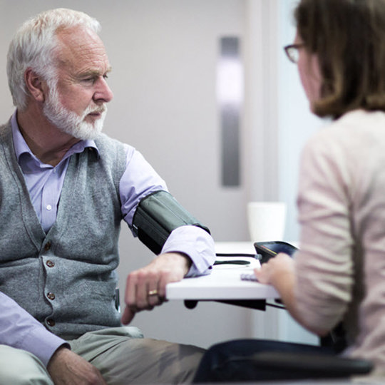 an elderly gentleman measures blood pressure