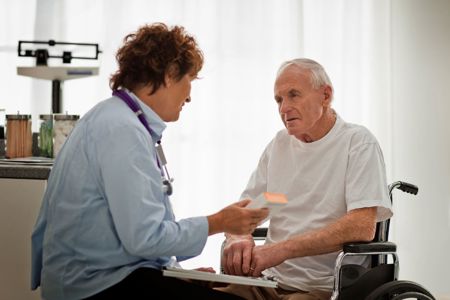 Doctor with a man in a wheelchair