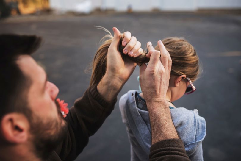Father fixing his daughters hair