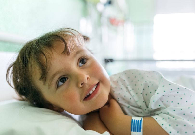 Little child lying in a hospital bed