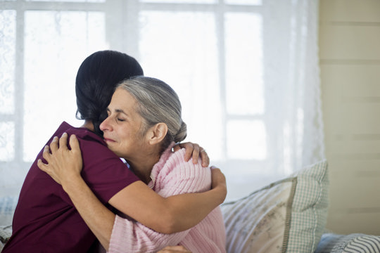 Nurse hugging a lady