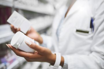 Woman comparing medicine bottles