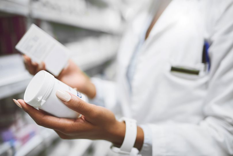 Woman comparing medicine bottles