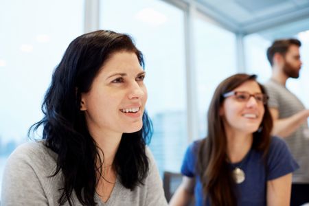 Women in a meeting smiling