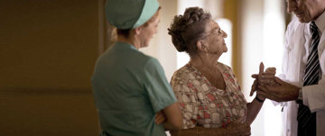 Doctor and nurse with an elderly woman
