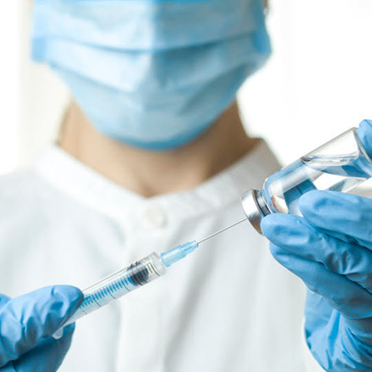 Doctor holding a syringe