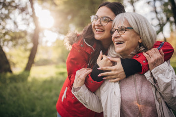 Young woman with grandmother in nature together